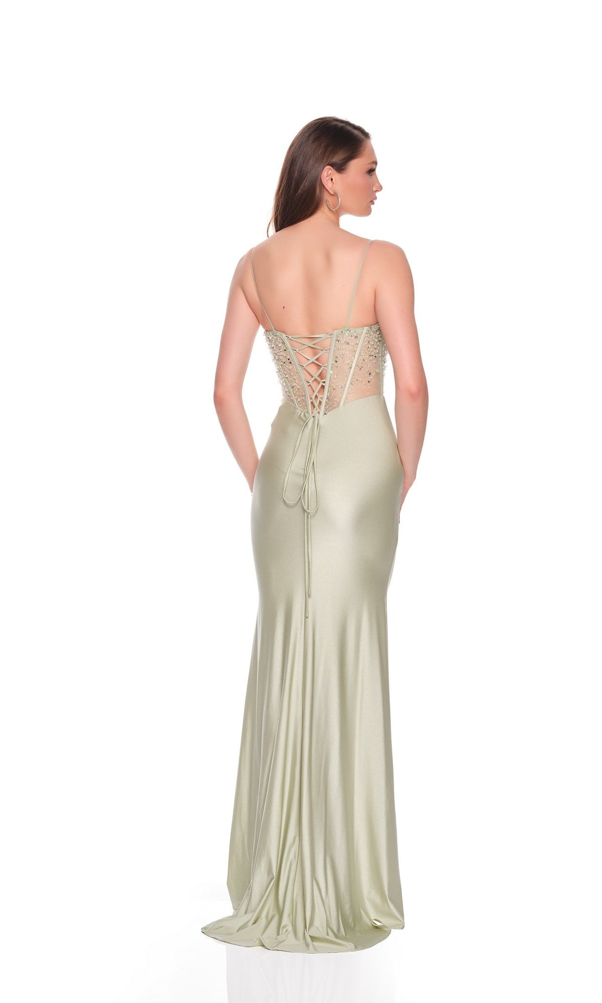 Woman modeling the Dave and Johnny 12704 long prom dress in light green, with a floor-length sheath skirt, thin straps, and lace-up back, standing against a plain white background.